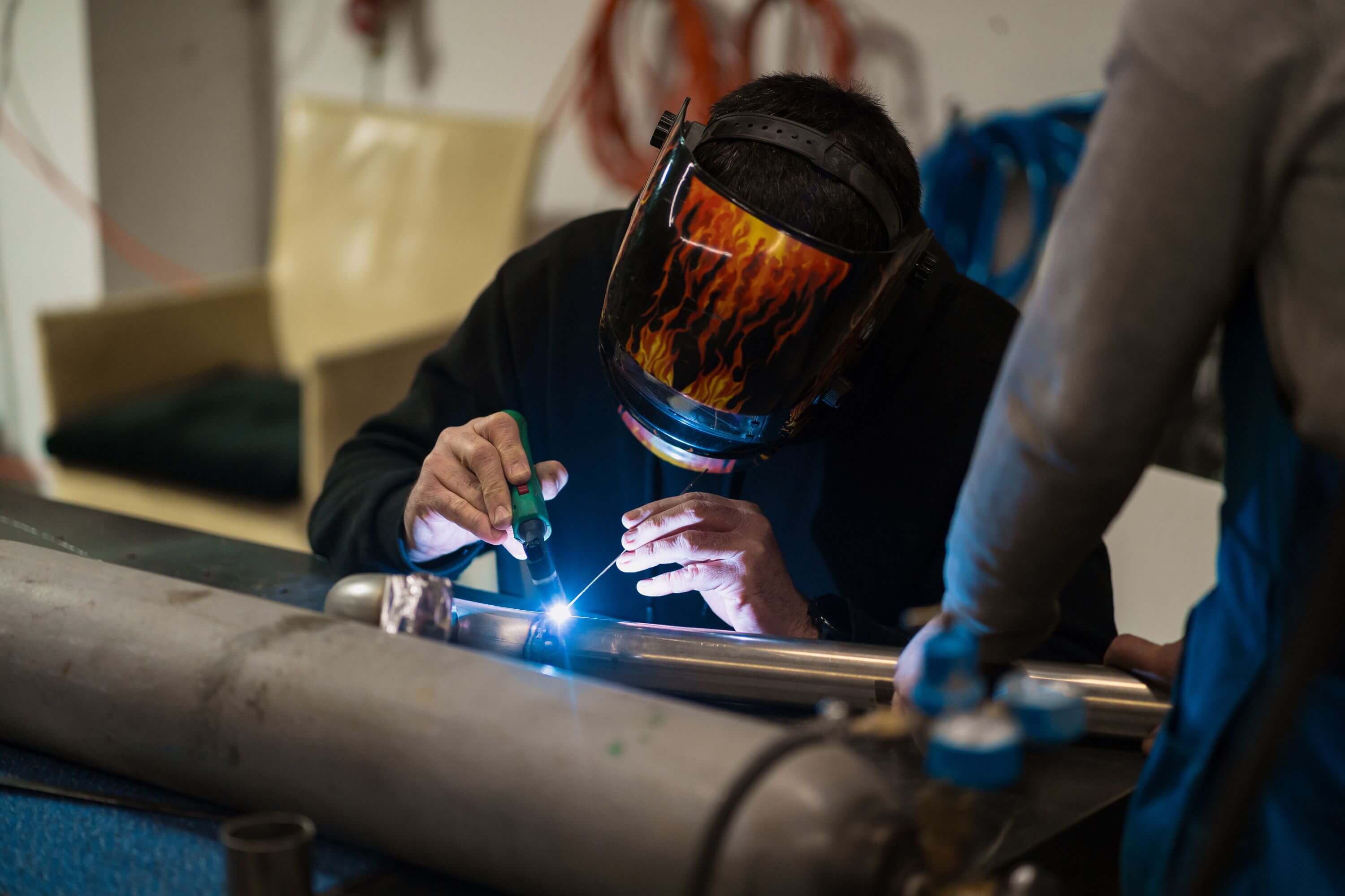 Professional welder working in fabrication shop